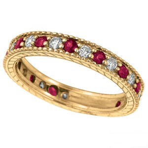 May include: A gold band ring with a row of red rubies and diamonds set in a milgrain design.