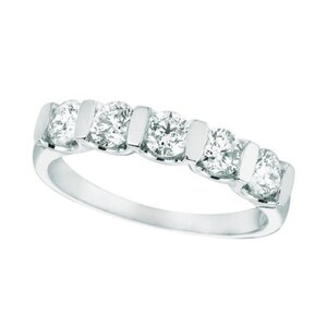 May include: A silver band with five round diamonds set in a channel setting.