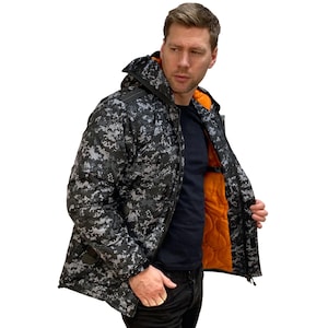 May include: A black and gray camouflage jacket with a black zipper and a black hood. The jacket has an orange lining.