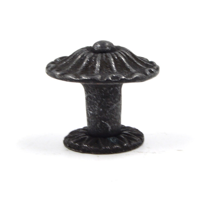 May include: A black cast iron mushroom-shaped knob with a fluted top and a round base.