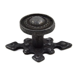 May include: Black metal cabinet knob with a round top and a cross-shaped base.