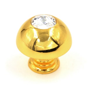 May include: Gold cabinet knob with a clear crystal top.