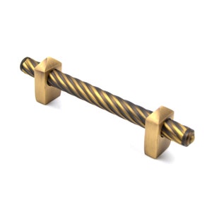 May include: A twisted brass cabinet pull with square ends. The pull has a dark and light brass finish.