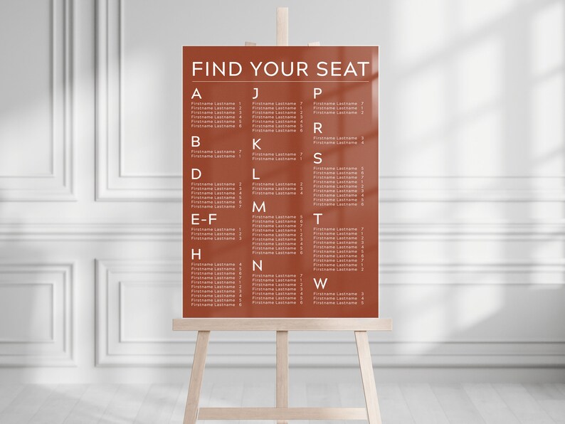 May include: A brown seating chart with white text that reads "FIND YOUR SEAT". The chart is divided into columns with letters from A to W and lists names under each letter.