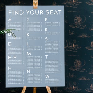 May include: A gray seating chart with the text "FIND YOUR SEAT" at the top. The chart is divided into columns with letters from A to W and lists names with corresponding numbers.