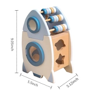 May include: A wooden rocket-shaped toy with a light blue and natural wood finish. It features an abacus on top and shape sorter cutouts on the side. The toy measures 9.05 inches tall, 5.5 inches wide, and 5.12 inches deep.