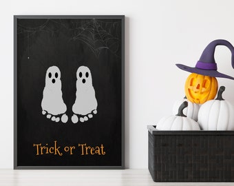 May include: A black framed chalkboard with two white ghost footprints and the text "Trick or Treat". A black basket with a pumpkin wearing a purple witch hat and white pumpkins sits in front of the chalkboard.