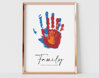 May include: A framed print with a handprint design in blue, red, and orange. The print says "Family" and "Hand in hand we create".