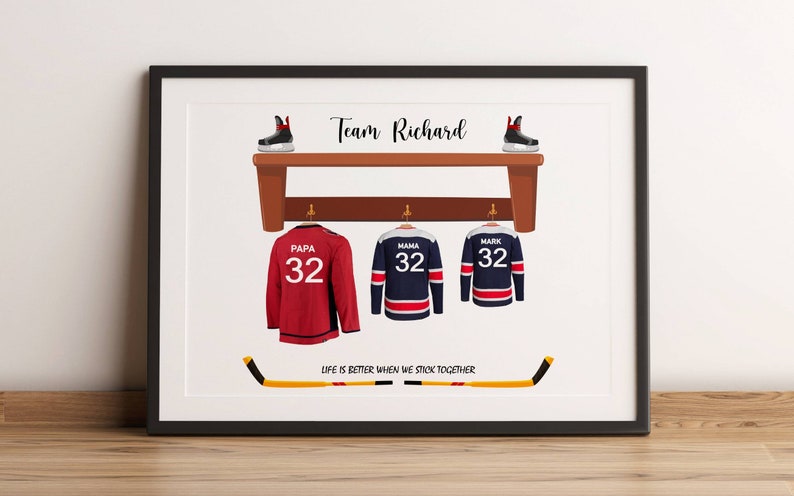 May include: Framed print featuring hockey-themed artwork. It displays three jerseys with the numbers 32, labeled "Papa," "Mama," and "Mark." Above, a bench holds hockey skates. The text "Team Richard" is at the top, with the phrase "Life is better when we stick together" at the bottom.