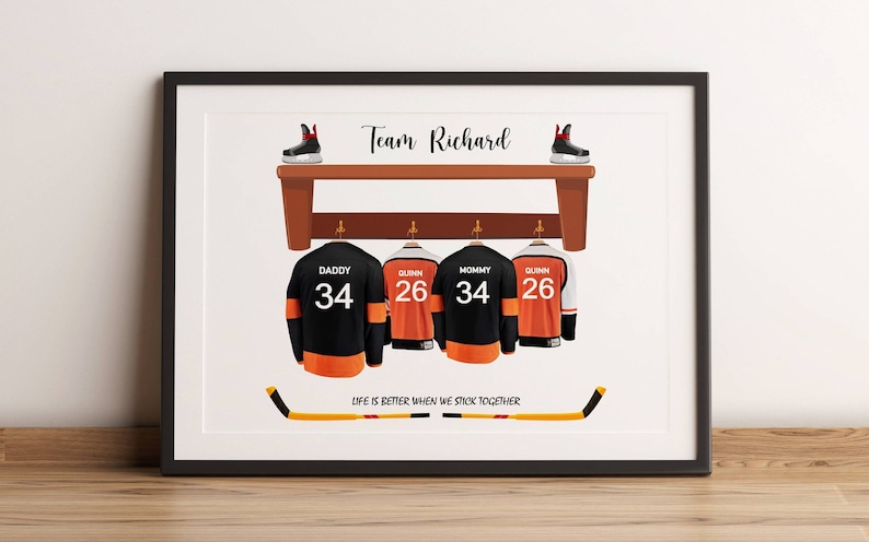 May include: Framed artwork with a hockey theme. It shows four jerseys with names and numbers, a bench with skates, and hockey sticks. The text reads "Team Richard" and "Life is better when we stick together."