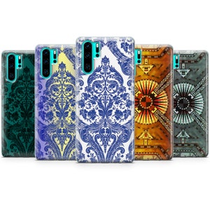 May include: Five different phone cases with various patterns. The cases are all clear and show the phone's camera lens. The patterns include a blue and white damask design, a green and black damask design, a yellow and blue damask design, a colorful geometric design, and a gray and blue geometric design.