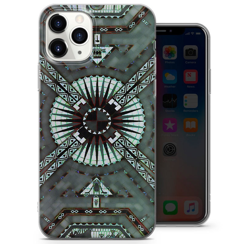 May include: A clear phone case with a geometric design featuring a black and white pattern with a green and blue center. The design is reminiscent of a stained glass window.