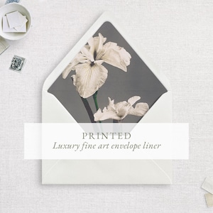 May include: An open white envelope featuring an interior liner printed with a dark gray background and two off-white iris flowers. The text PRINTED Luxury fine art envelope liner is centered over the lower portion of the envelope.