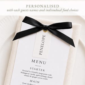 May include: A white menu card with black text featuring a starter and main course, topped with a black satin ribbon and a small white tag labeled Penelope. The text reads: PERSONALISED with each guests names and indivudual food choices.