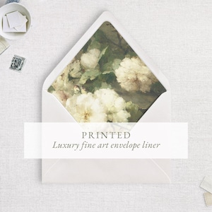 May include: White envelope with a floral print liner. The liner features a painting of white flowers and green foliage. The text "PRINTED Luxury fine art envelope liner" is displayed on the front of the envelope.