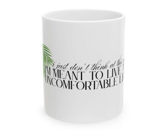 May include: White ceramic mug with a green leaf design and the text "i just don't think at this point i'm meant to live a uncomfortable life"