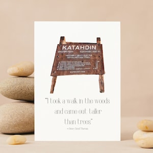 May include: A watercolour illustration of a wooden sign with the words "Katahdin, Baxter Peak, Elevation 5267 ft, Northern Terminus of the Appalachian Trail" on it. The sign is sitting on a wooden easel. The quote "I took a walk in the woods and came out taller than trees." by Henry David Thoreau is written below the image.