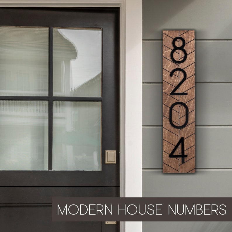 May include: Modern house numbers made of wood with a chevron pattern. The numbers are black and the wood is a dark brown. The numbers are 8204.