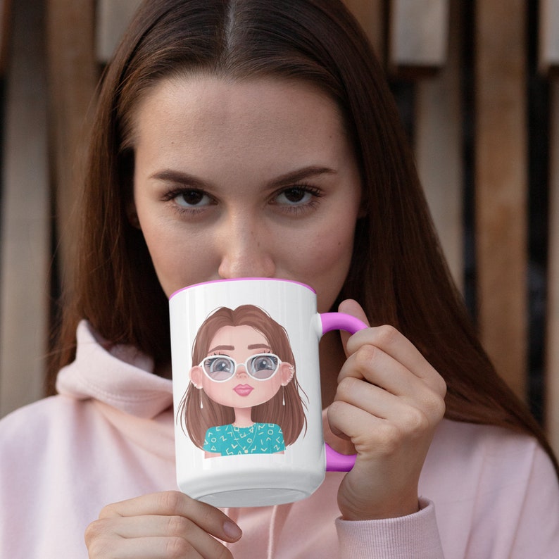 May include: White ceramic mug with a pink rim and handle. The mug features a cartoon illustration of a woman with brown hair wearing glasses and a turquoise shirt with white polka dots.