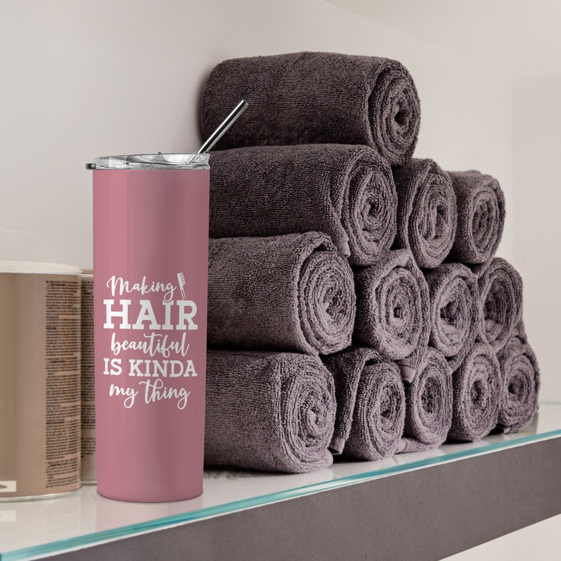 May include: Pink stainless steel tumbler with a white design that says "Making Hair beautiful is kinda my thing".