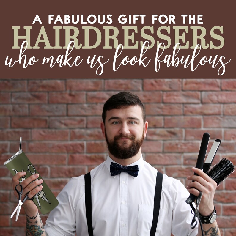 May include: A man wearing a white shirt, black bow tie, and suspenders holds a green tumbler with a pair of scissors and a black curling iron with a brush attachment. The background is a brick wall with the text "A FABULOUS GIFT FOR THE HAIRDRESSERS who make us look fabulous".