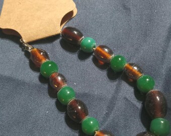 A green and brown beaded bracelet.