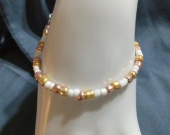 Golden and white beaded bracelet.