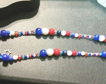 A Patriotic themed red, white and blue beaded long necklace.