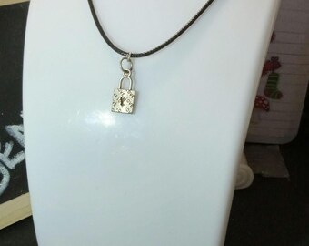 A corded adjustable necklace with a lobster clasp and a padlock love charm.
