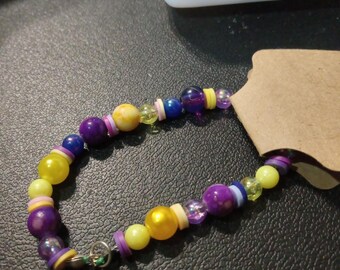 A pretty purple and yellow beaded bracelet.