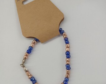 A pretty golden and blue beaded bracelet.