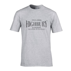 May include: A gray t-shirt with black text that reads "1913-2006 Highbury London The Home of Football".