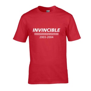 May include: Red t-shirt with white text that reads "INVINCIBLE" with a line of "W"s below and "2003-2004" below that.