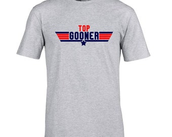 May include: A gray t-shirt with a red and blue graphic that says "TOP GOONER" with a star in the middle.