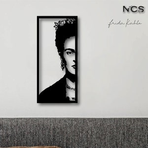 May include: Black and white silhouette of Frida Kahlo's face in a black frame. The image is titled "Frida Kahlo" and has the initials "NCS" in the top right corner.