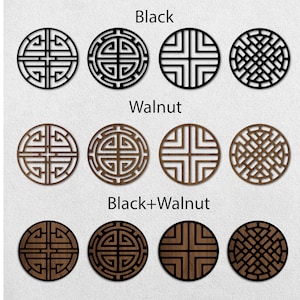 May include: Three sets of four decorative round wood wall plaques with geometric designs. The first set is black, the second set is walnut, and the third set is a combination of black and walnut.