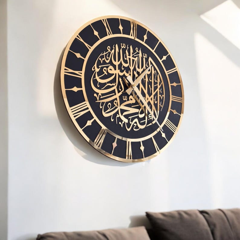 May include: A black and gold wall clock with Roman numerals and Arabic calligraphy. The clock has a black background and gold accents.