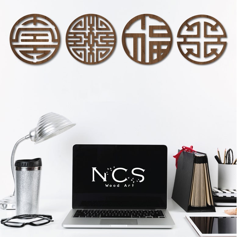 May include: Four brown wooden wall decor pieces with intricate geometric designs. The designs are inspired by traditional Chinese symbols. The pieces are arranged in a row on a white wall.