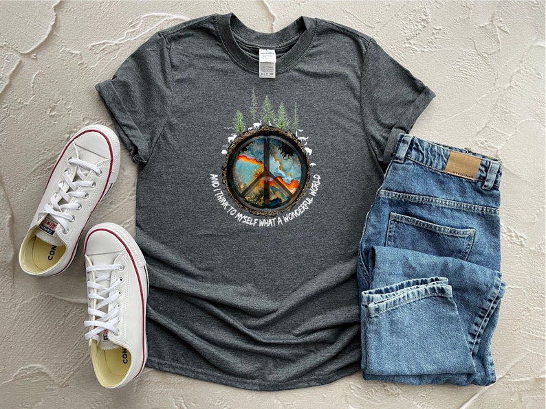 This is a cotton or cotton-polyester mix shirt. This shirt has a Hippie design. The color is heather gray.