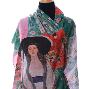 May include: A silk scarf with a pink and green background featuring a painting of a woman in a black hat and white dress. The painting is a reproduction of Gustav Klimt's "The Lady with the Ermine".