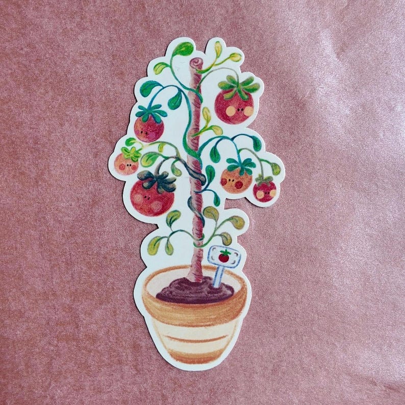 May include: A whimsical sticker featuring a cartoon tomato tree in a terracotta pot. The tree has red tomatoes with smiling faces, green leaves, and a sign with a tomato. The sticker is on a pink background.