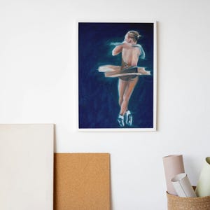 May include: A framed art print of a ballet dancer in a graceful pose. The artwork features a dark blue background with the dancer highlighted in soft, light colors. The dancer is wearing a tutu and pointe shoes.