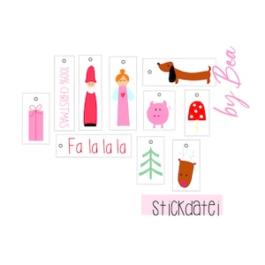 May include: Set of nine colorful gift tags with various Christmas-themed illustrations, including a Santa, angel, pig, dachshund, mushroom, Christmas tree, reindeer, and a gift box. The tags are white with black outlines and have a hole at the top for string. The text "100% Christmas" and "Fa la la la" are printed on the tags. The text "Stickdatei by Bea" is printed in pink at the bottom of the image.