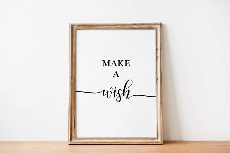 May include: A framed print with the text "MAKE A WISH" in black cursive font on a white background.