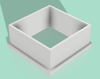 May include: A white, square-shaped object with a raised base. The object has a hollow interior and is made of a solid, opaque material. The design is simple and geometric, with clean lines and a minimalist aesthetic.