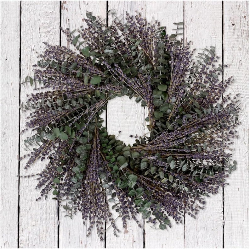May include: A lavender and eucalyptus wreath with a natural, rustic look. The wreath is made with dried lavender and eucalyptus branches, and it has a diameter of approximately 12 inches.