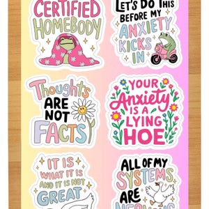 May include: A sheet of colorful stickers with whimsical designs and text. The stickers feature phrases like "Certified Homebody," "Let's Do This Before My Anxiety Kicks In," and "Thoughts Are Not Facts." The stickers have a cartoonish style with a variety of illustrations.