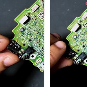May include: Close-up of a green circuit board with various electronic components. The board is being held, showing black connectors and small, detailed circuitry. The image highlights the intricate design of the electronic device.