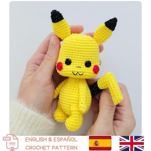 May include: A handmade yellow crochet Pikachu doll with black-tipped ears, red cheeks, and a black tail. The doll has black button eyes and a smiling mouth. The image includes text that says "ENGLISH & ESPAÑOL CROCHET PATTERN".