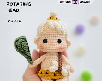May include: A crochet doll featuring a pale skin tone, light hair, and a yellow skirt with black triangular patterns. The doll holds a green club and has a white bone accessory. Text reads 360° ROTATING HEAD, LOW-SEW, CROCHET PATTERN, ESPAÑOL, ENGLISH.